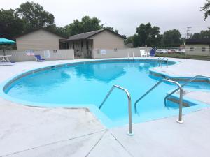 a large swimming pool with blue water at Campus Inn Baraboo in Baraboo