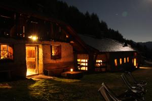 a house at night with a candle in front of it at Nestalp Malga Campo in Peio