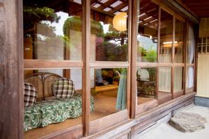 a room with a bench inside of a house at Guest House Wagaranchi Kai in Kumano