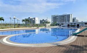 a large swimming pool with a slide in front of buildings at PSA Nghi Sơn Condotel in Thanh Hóa