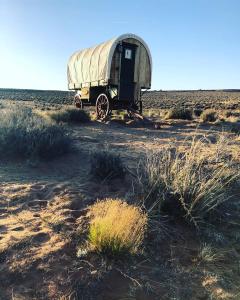 a truck is parked on the side of a dirt field at Shash Dine' EcoRetreat in Page