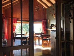 a kitchen and dining room with a table and a dining room at Las Juntas Ecolodge in Puyehue