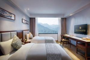 Postel nebo postele na pokoji v ubytování Fliport Garden Hotel Wuyishan + 37 fotografií