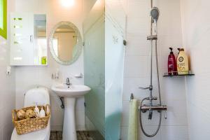 two images of a bathroom with a sink and a shower at Sunny House in Pyeongchang