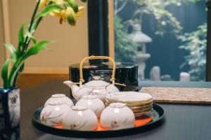 a tray with a tea set on a table at Miro Sanjo Umemiyacho Tei in Kyoto
