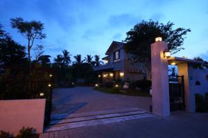 a house with a light pole in front of a driveway at Sweet Heart B&B in Ji'an