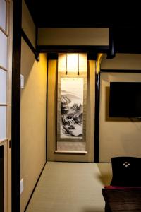 a hallway of a train with a painting on the wall at Miro Shichjo Hanabatakecho Tei in Kyoto