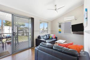 a living room with a couch and a table at Nobby Beach Holiday Village in Gold Coast
