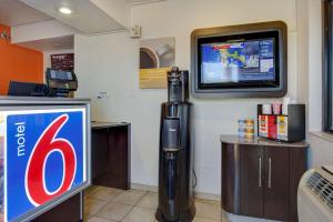 a coke machine in a room with a tv at Motel 6-Tempe, AZ - Broadway - ASU in Tempe