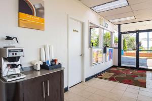 a office with a coffee machine on a counter and a door at Motel 6-Cleveland, TN in Cleveland