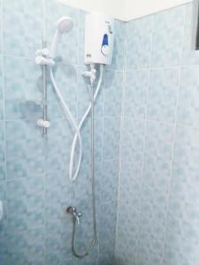 a shower with a shower head in a bathroom at D downhill'Place in Oslob