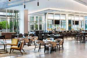 a restaurant with tables and chairs and windows at Hyatt Regency McCormick Place Chicago in Chicago