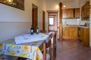 a kitchen with a table and some bottles of wine at Azienda Agricola Fornacelle in San Gimignano