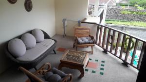 a living room with a couch and chairs on a balcony at Papillon Residence in Choeng Mon Beach