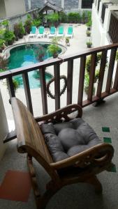 a chaise lounging chair on a balcony with a pool at Papillon Residence in Choeng Mon Beach