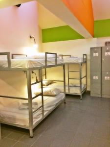 a room with three bunk beds in a dorm room at Campbell Inn in Singapore