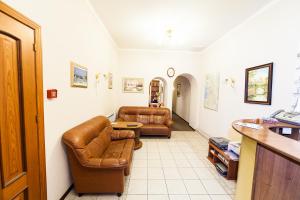 a living room with two leather chairs and a couch at Амулет на Малой Морской in Saint Petersburg