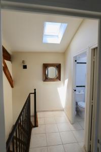 a bathroom with a skylight and a toilet at Maison de Margot in Peyriac-Minervois