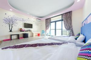 Postel nebo postele na pokoji v ubytování Kenting Aqual Inn