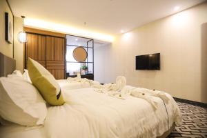 Postel nebo postele na pokoji v ubytování Guangzhou Homies Hotel