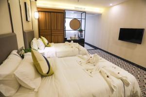 Postel nebo postele na pokoji v ubytování Guangzhou Homies Hotel
