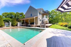 an image of a swimming pool in front of a house at #OB Pool House in Oak Bluffs