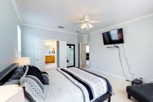 a bedroom with a bed and a flat screen tv at Peaceful at Vinca Pass in San Antonio