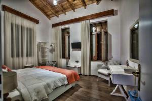 a bedroom with a bed and a desk and a chair at Maya's Boutique Residence in Rethymno