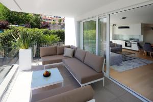 a living room with a couch and a table at Designed Apartment with swimming pool near the beach in Opatija