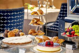 a table with various pastries and cakes and pies at Relais & Châteaux Heritage Hotel in Madrid