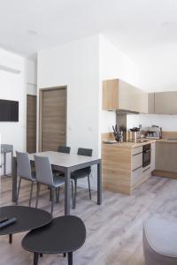 a kitchen and dining room with a table and chairs at Aux Iles d'Or in Hyères