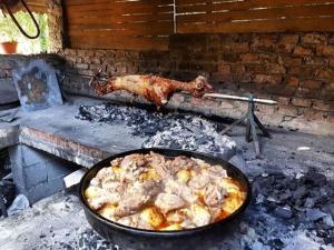 a rooster and a chicken cooking in a grill at Rafting Camp Tara 87 in Hum