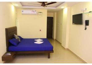 a room with a blue bed in a room at Deluxe Room near Calangute Mall in Calangute