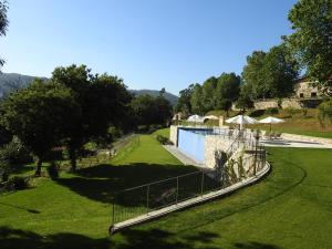 a view of a yard with a swimming pool at Encosta Dos Túneis - Turismo E Lazer in Sever do Vouga