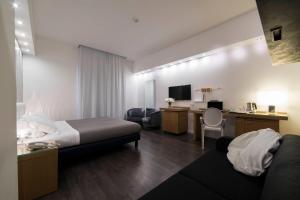 a hotel room with a bed and a desk at Hotel Montestella in Salerno