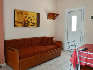 a living room with a couch and a table at Vergina in Skala Potamias