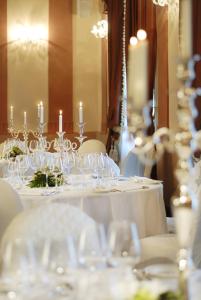 a table with wine glasses and candles on it at GH Palazzo Suite & SPA in Livorno