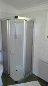 a shower with a glass door in a bathroom at Apartement Postalm in Abtenau