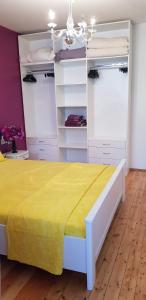 a bedroom with a large bed with a yellow bedspread at Florata apartment in Burgas City