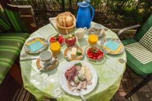 a table with plates of food and orange juice at Haus Arvert in Ostseebad Koserow