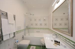 a bathroom with a tub and a toilet and a sink at Villa Guarracino Amalfi in Amalfi +43 photos