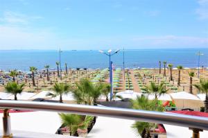 a view of a beach with chairs and umbrellas at Hotel Virginia in Durrës