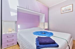 a bedroom with a bed with an umbrella on it at AURORA house with apartments in Zambratija