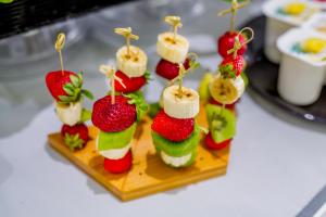 a bunch of appetizers on a plate on a table at Ossuna Bay Hotel Boutique in Cefalù