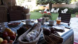 a table with bread and other foods on it at Sous les Remparts in Solignac
