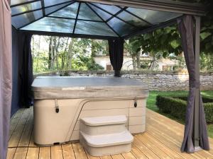 a bar on a deck under a gazebo at Unique Holiday Home in Virton with Jacuzzi in Latour