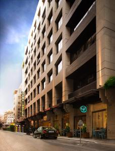 a car parked in front of a large building at Gems Hotel in Beirut