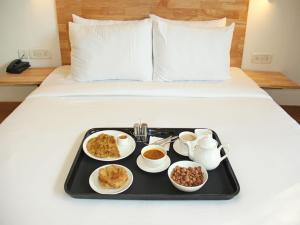 a tray of breakfast food on a bed at Hotel Sham Villa in Amritsar