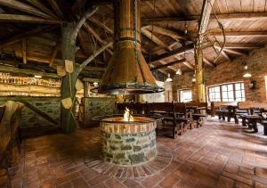 a large room with a fireplace in a restaurant at Kazmarka in Malá Morávka