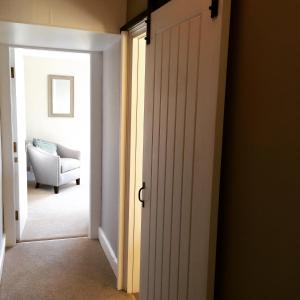 an open door to a room with a chair at Baie Mooar House, Boutique B&B in Ramsey